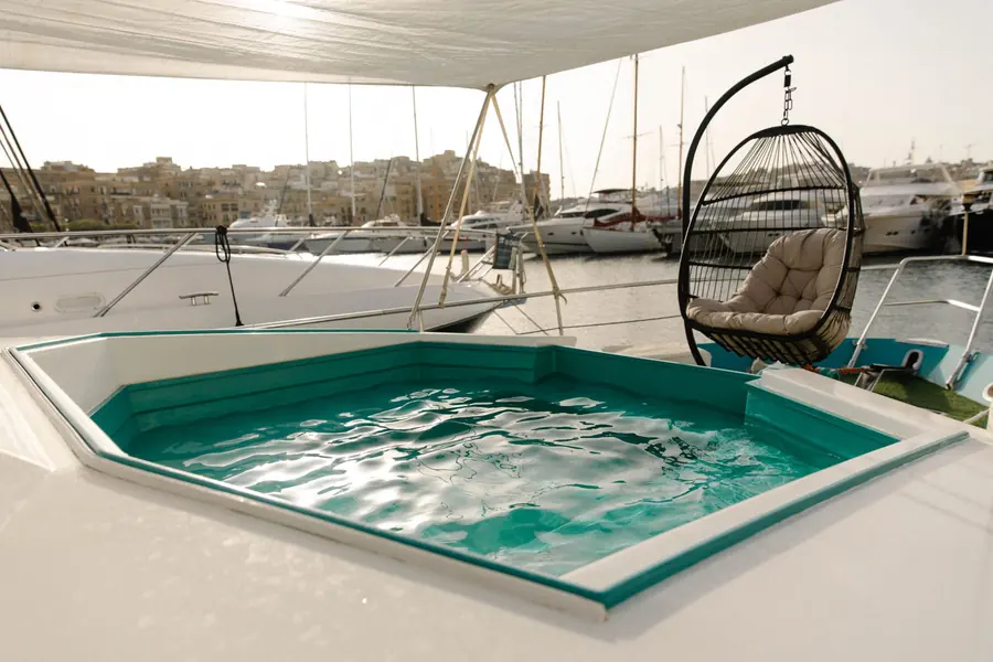 Bow plunge pool with hanging chair under the sun sail at Grand Harbour Marina