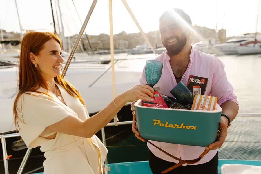 Guests sharing a welcome cooler of drinks on deck