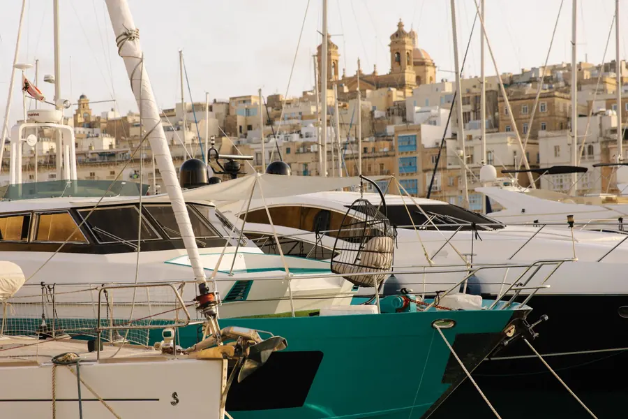 Boats moored in the marina below the church domes of the Three Cities