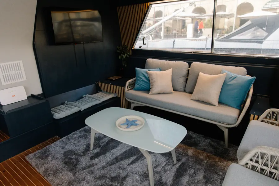 Sofa with cushions and coffee table in the saloon