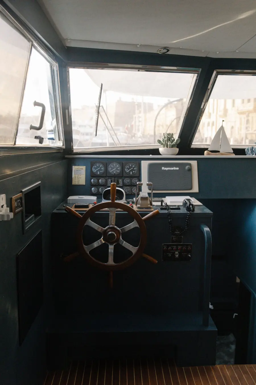 Wooden ship's wheel and instruments at the helm of Canaima