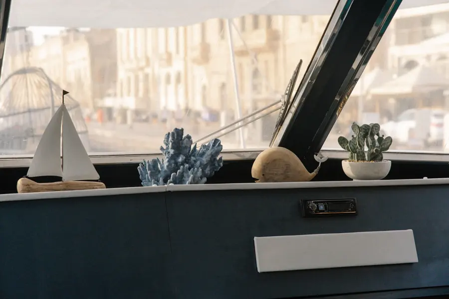 Nautical decoration on the helm with Birgu's limestone facades behind