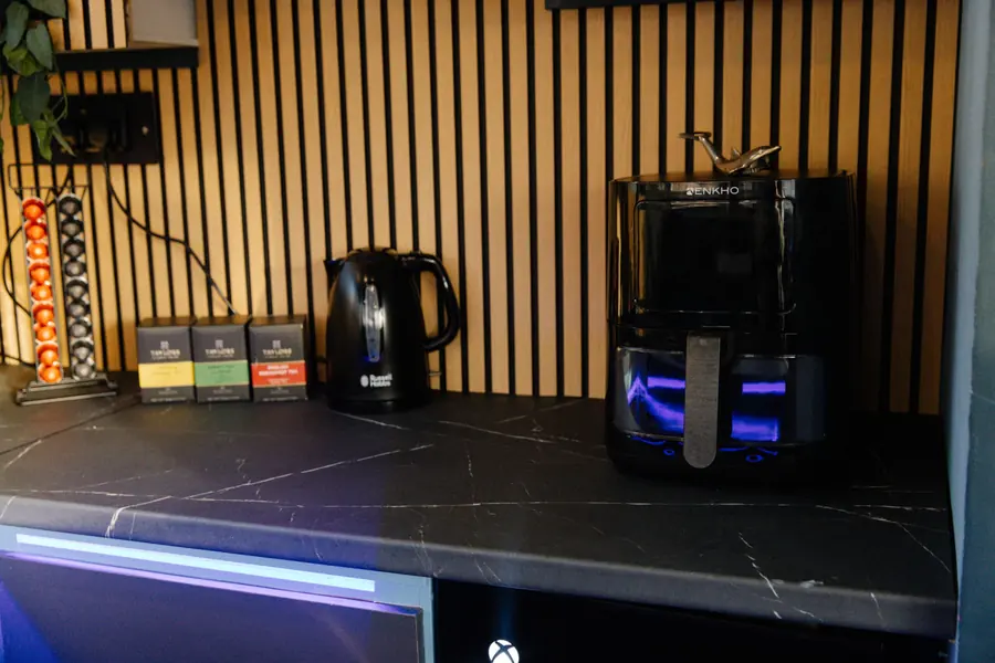 Coffee machine, kettle and air fryer on the kitchen counter