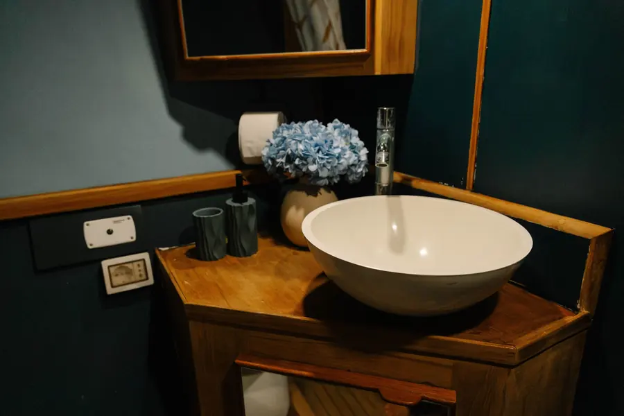 Bathroom vanity with bowl basin on a teak top