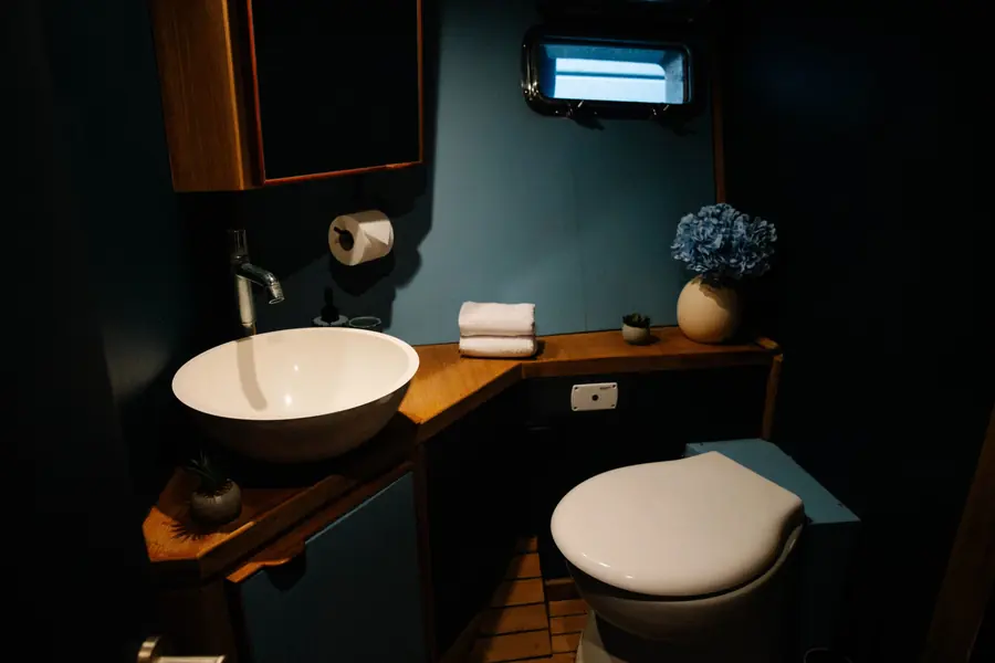 Bathroom with basin, marine toilet and porthole