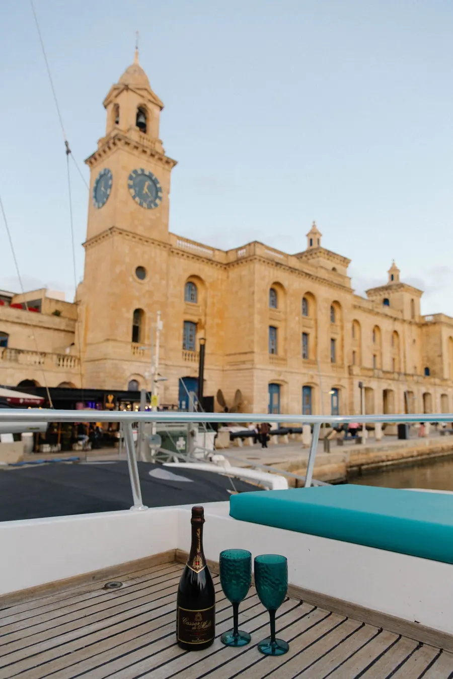 Bottle and glasses on the flybridge facing the Malta Maritime Museum clock tower