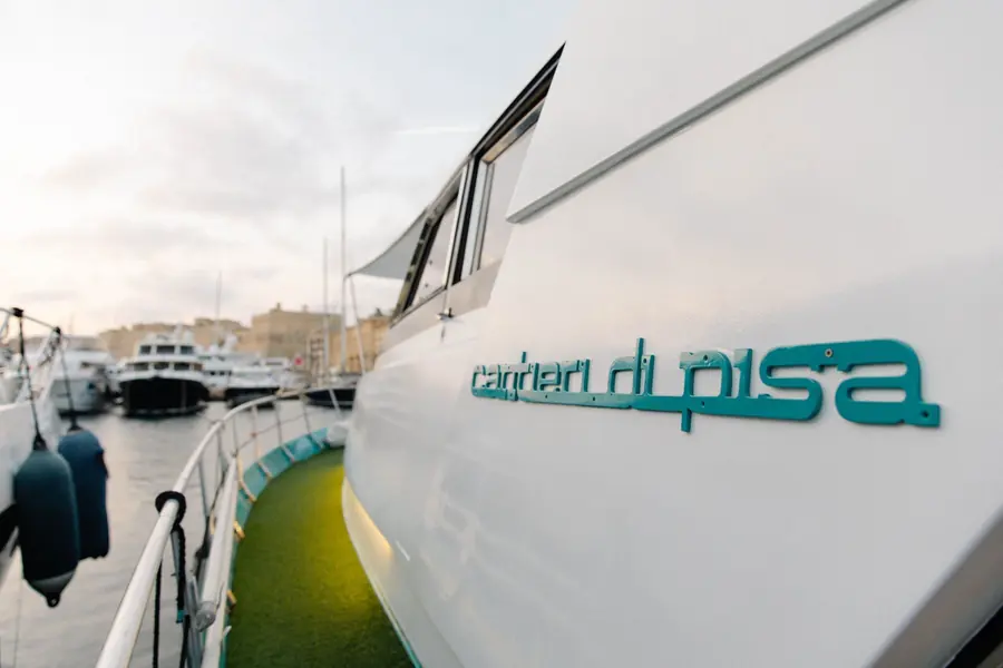 Side deck of the classic Cantieri di Pisa motor yacht Canaima in Grand Harbour Marina at sunset